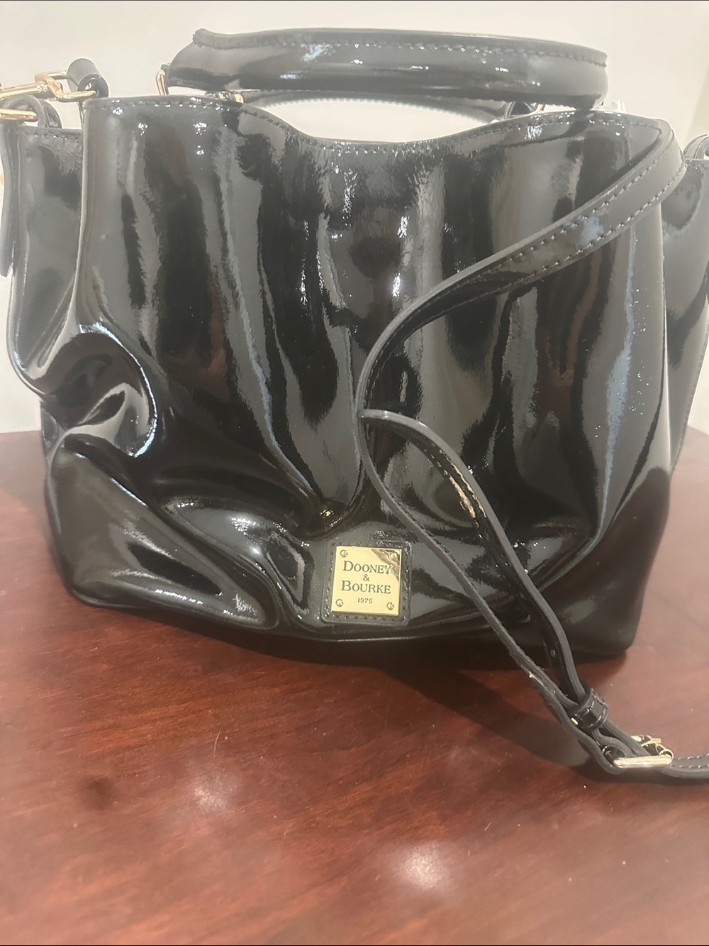 Dooney & Bourke Black Patent Shoulder Bag with Gold Plaque